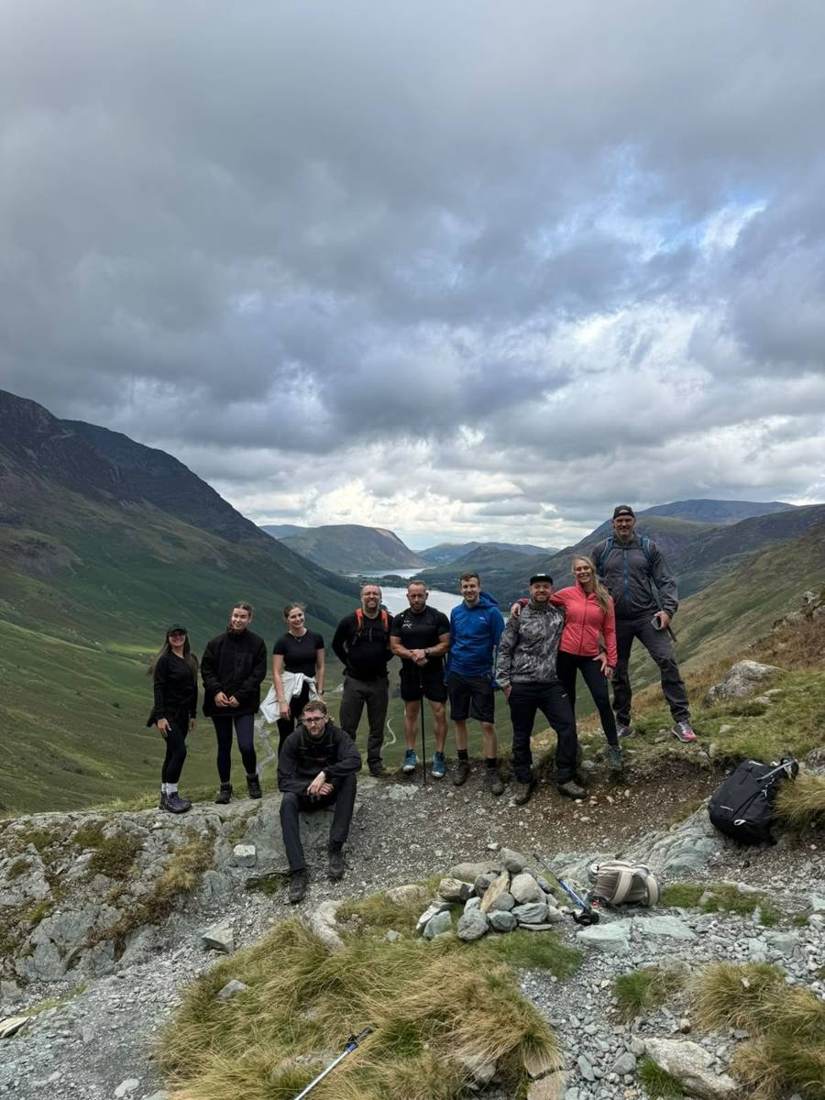 A Solna group of ten near the summit of Fleetwith Pike with Buttermere behind