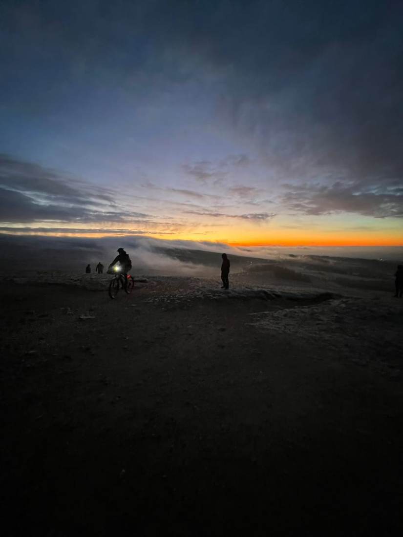 Walkers on a summit at sunrise